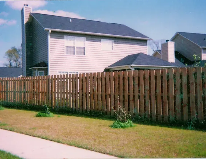 A house with a wooden fence in front of it