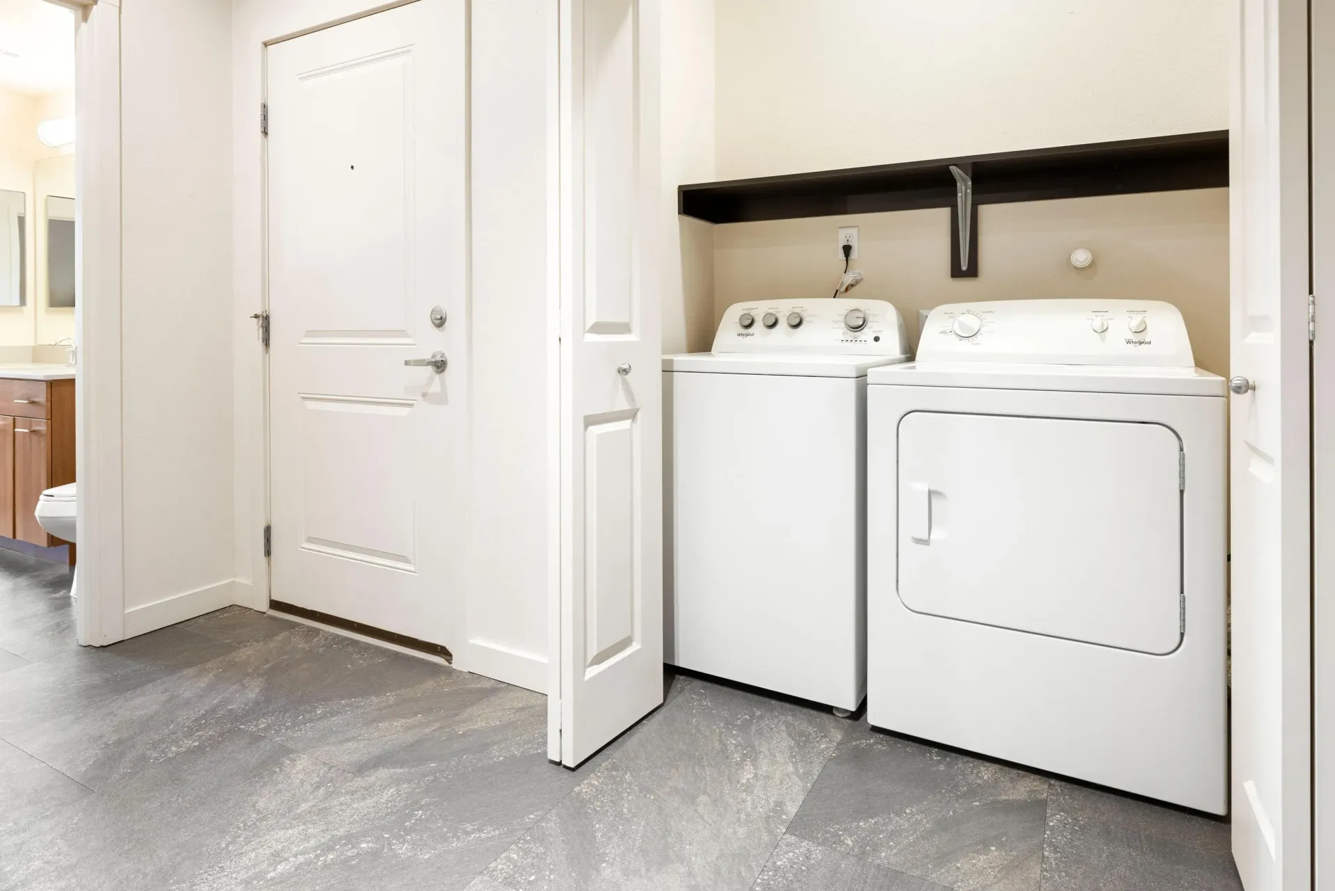 In-unit laundry closet with a washer and a dryer side by side.