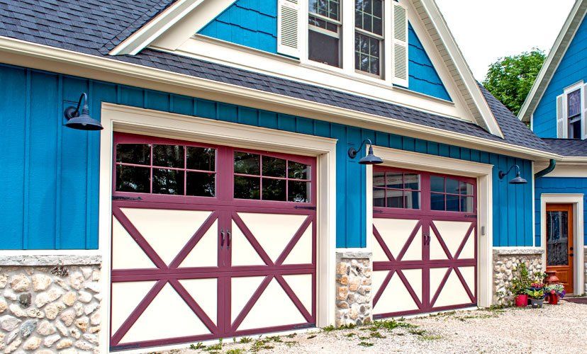 Blue and cream garage with burgundy accents and stone accents.