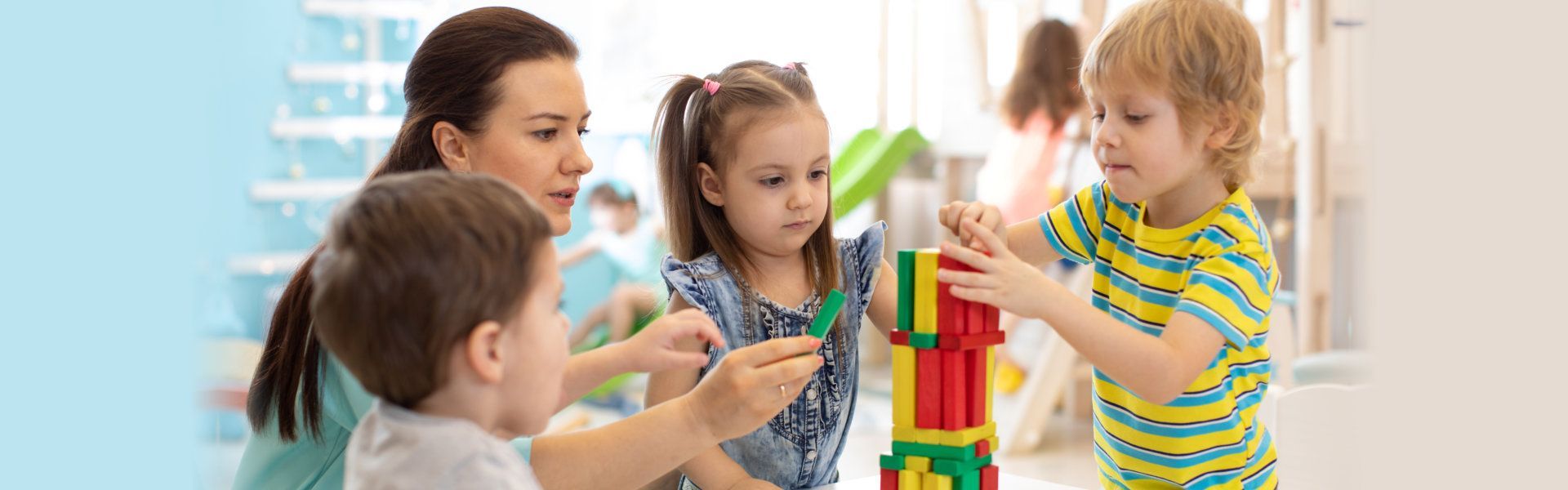 A group of children are playing with blocks in a room.