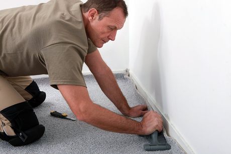 man installing the floor carpet