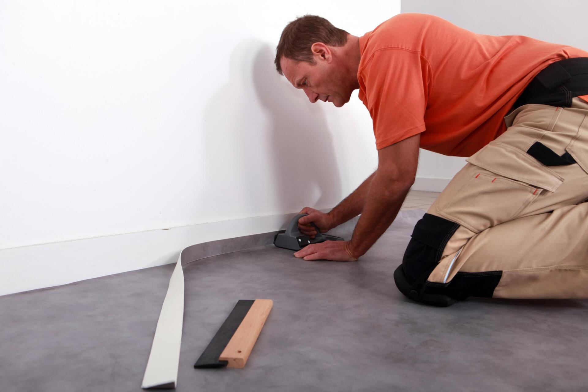 man cutting the edges of the carpet