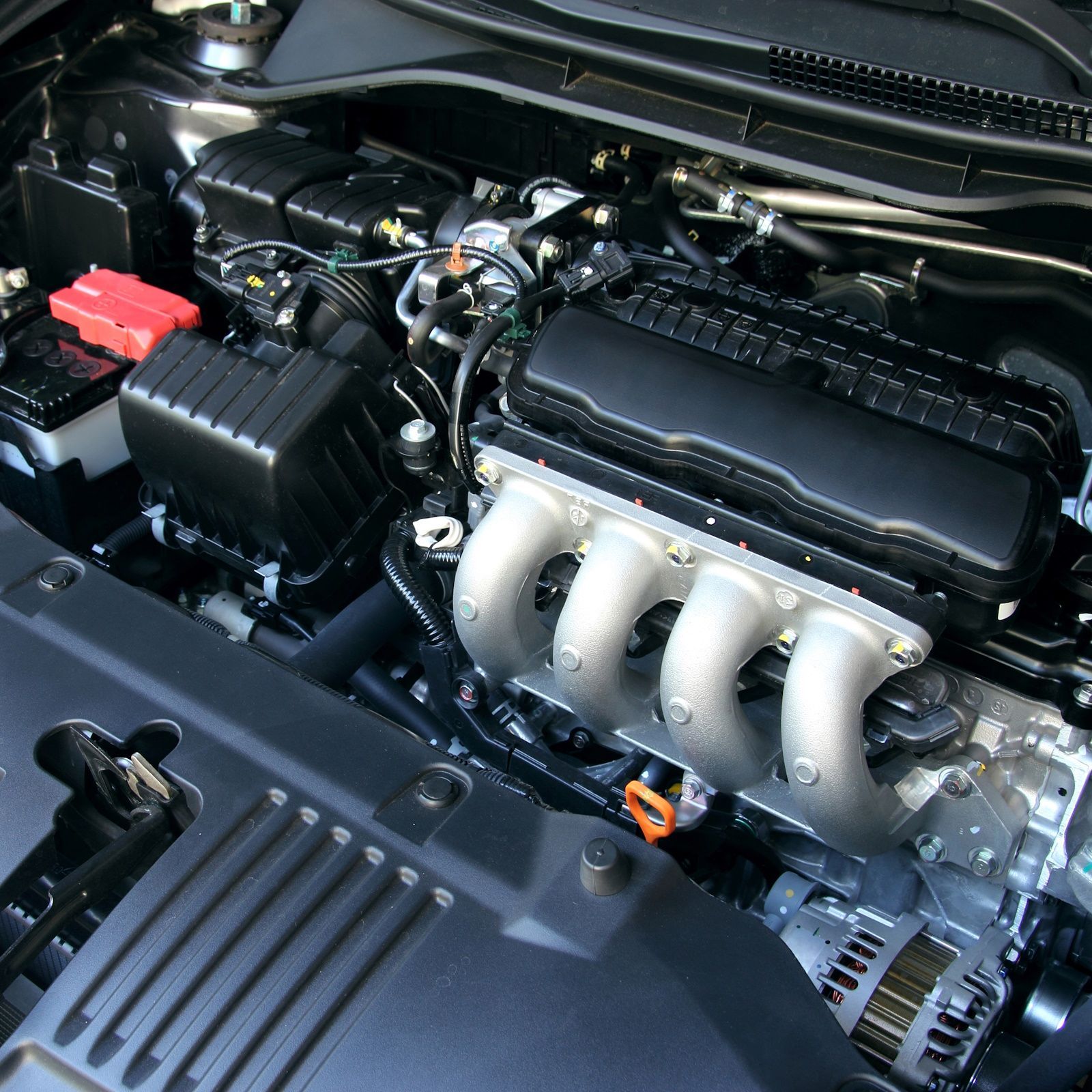 A close up of a car engine with a bunch of gauges on it.