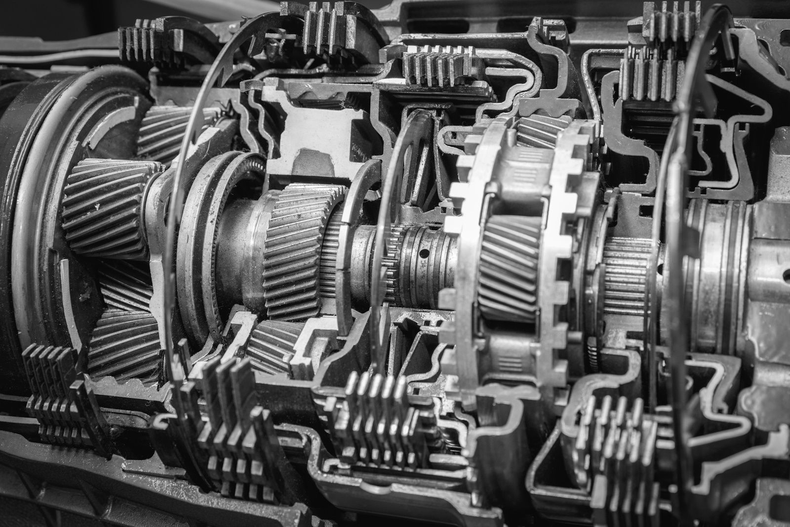 A black and white photo of a cut in half gearbox.