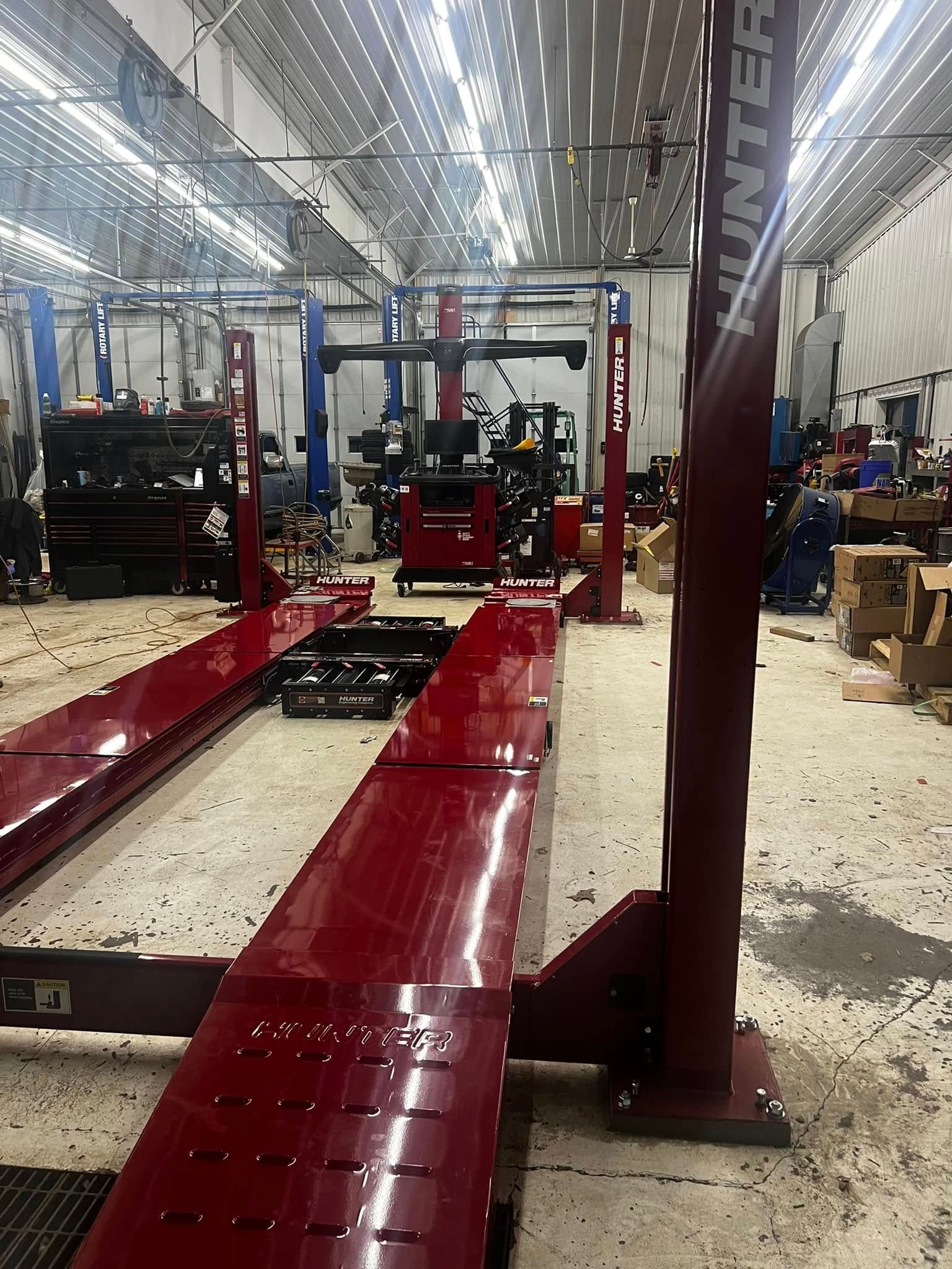 A large garage with a lot of machinery and a red ramp.