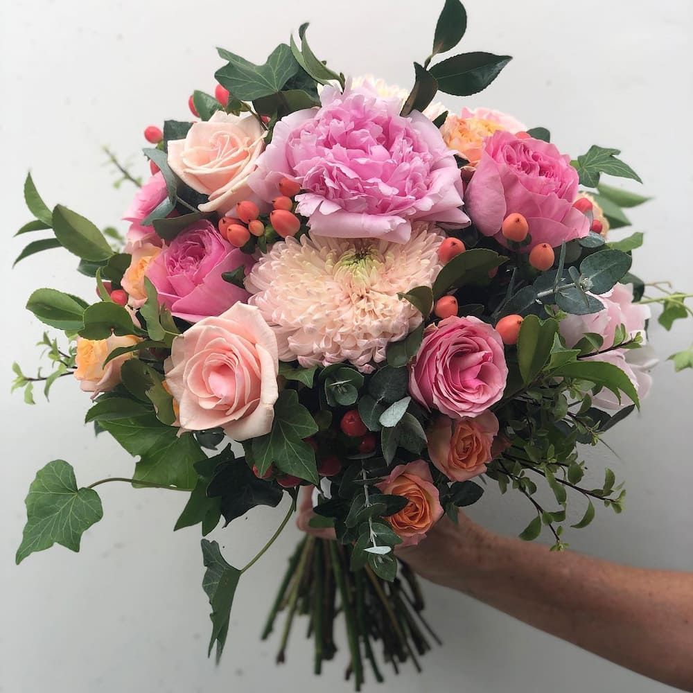 A Person Is Holding A Bouquet Of Pink And Orange Flowers — Clover Country Flowers and Gifts In Toowoomba, QLD