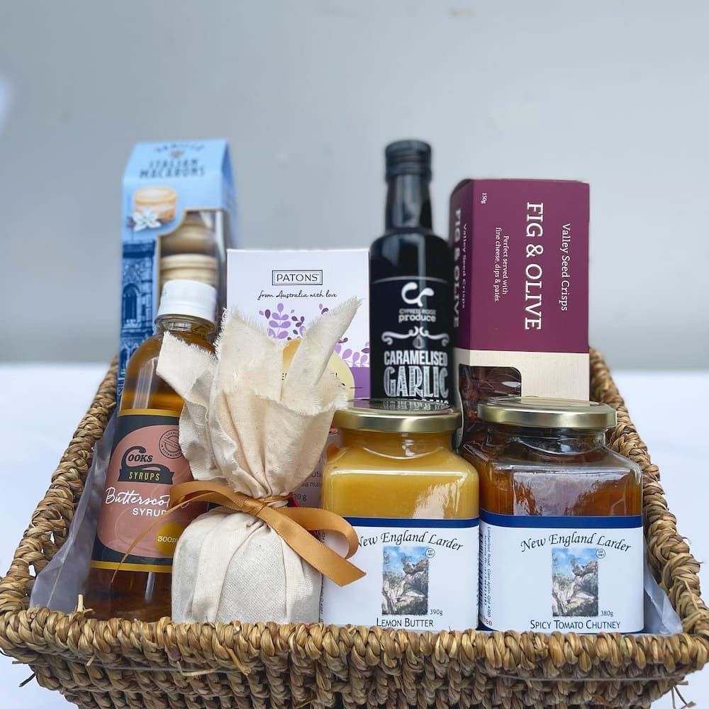 A Wicker Basket Filled With Bottles And Jars Including Fig & Olive — Clover Country Flowers and Gifts In Pittsworth, QLD