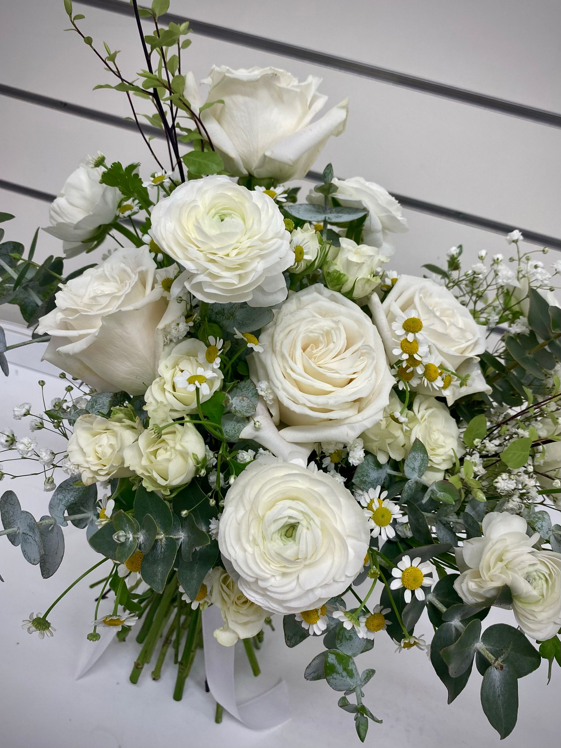 A Person Is Holding A Single Red Rose Wrapped In Brown Paper — Clover Country Flowers and Gifts In Pittsworth, QLD