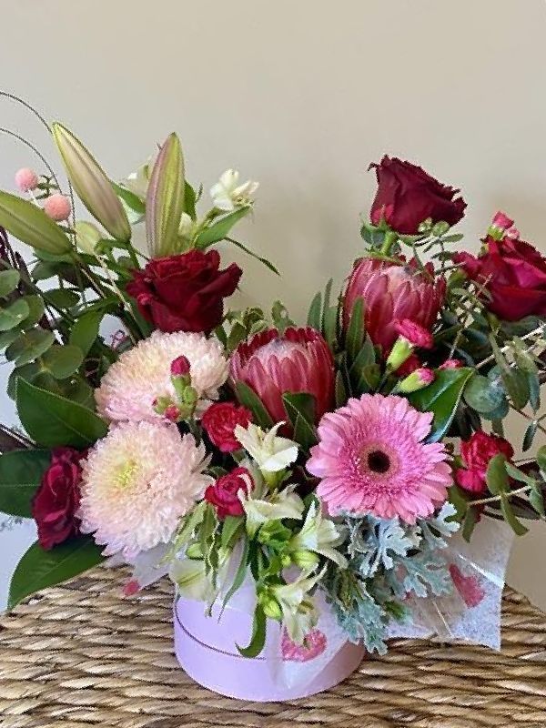 A Woman In An Apron Is Holding A Large Bouquet Of Flowers — Clover Country Flowers and Gifts In Pittsworth, QLD