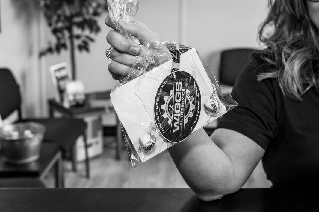 A woman is holding a bag of food in her hand.