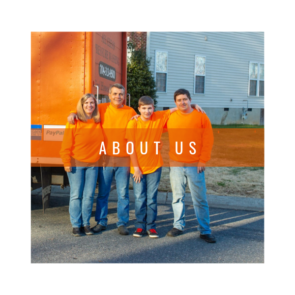 A family of four stands outdoors in front of an orange truck, wearing matching orange shirts with the text
