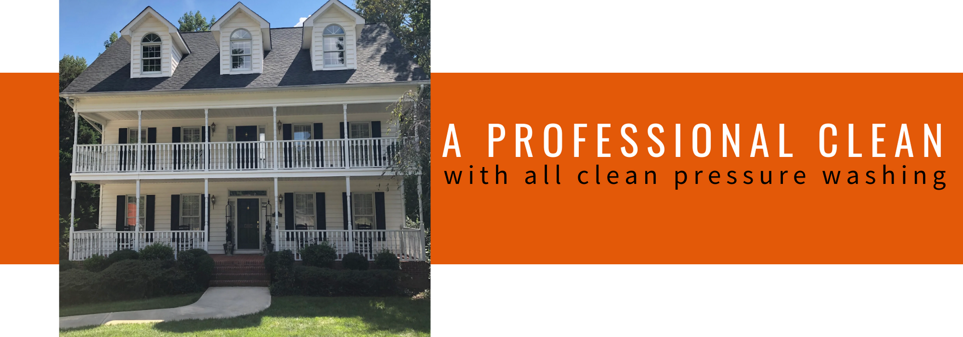 A white, two-story house with dormer windows next to an orange banner that reads,