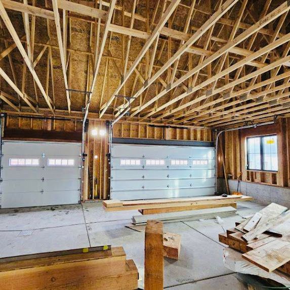 A garage under construction with a large garage door