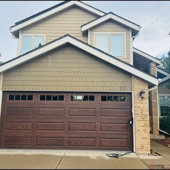 A large house with a large brown garage door