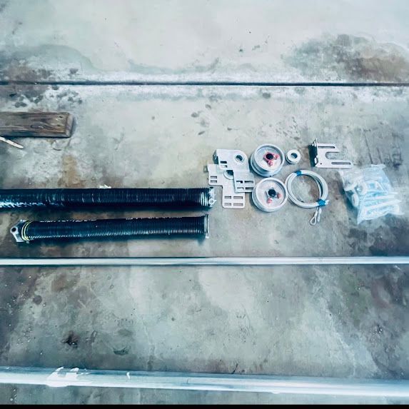 A close up of a garage door spring on a table.