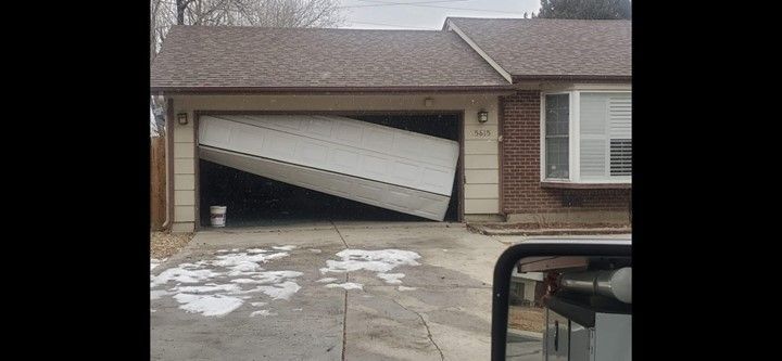 A garage door that has fallen off of a house.