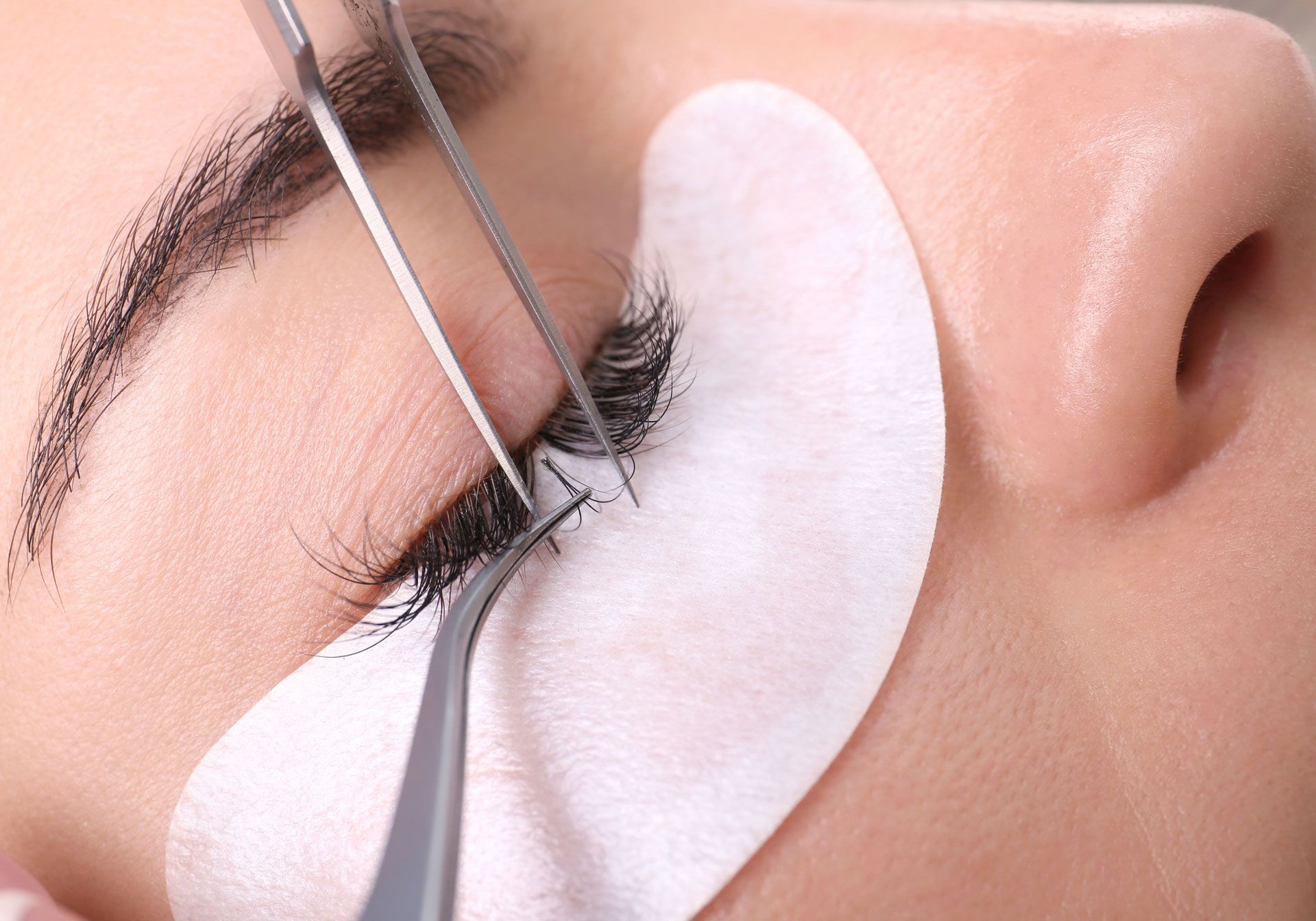 A close up of a woman getting eyelash extensions