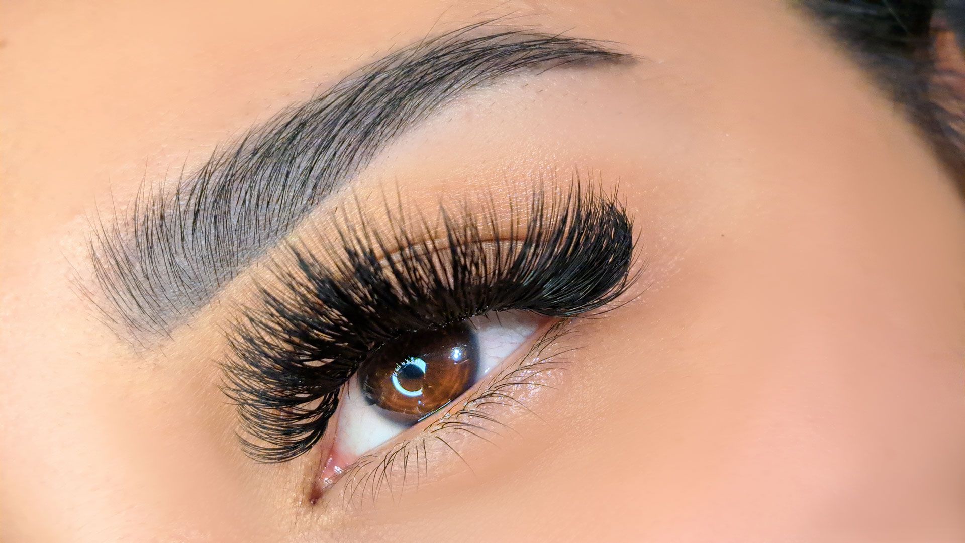 A close up of a woman 's eye with long eyelashes
