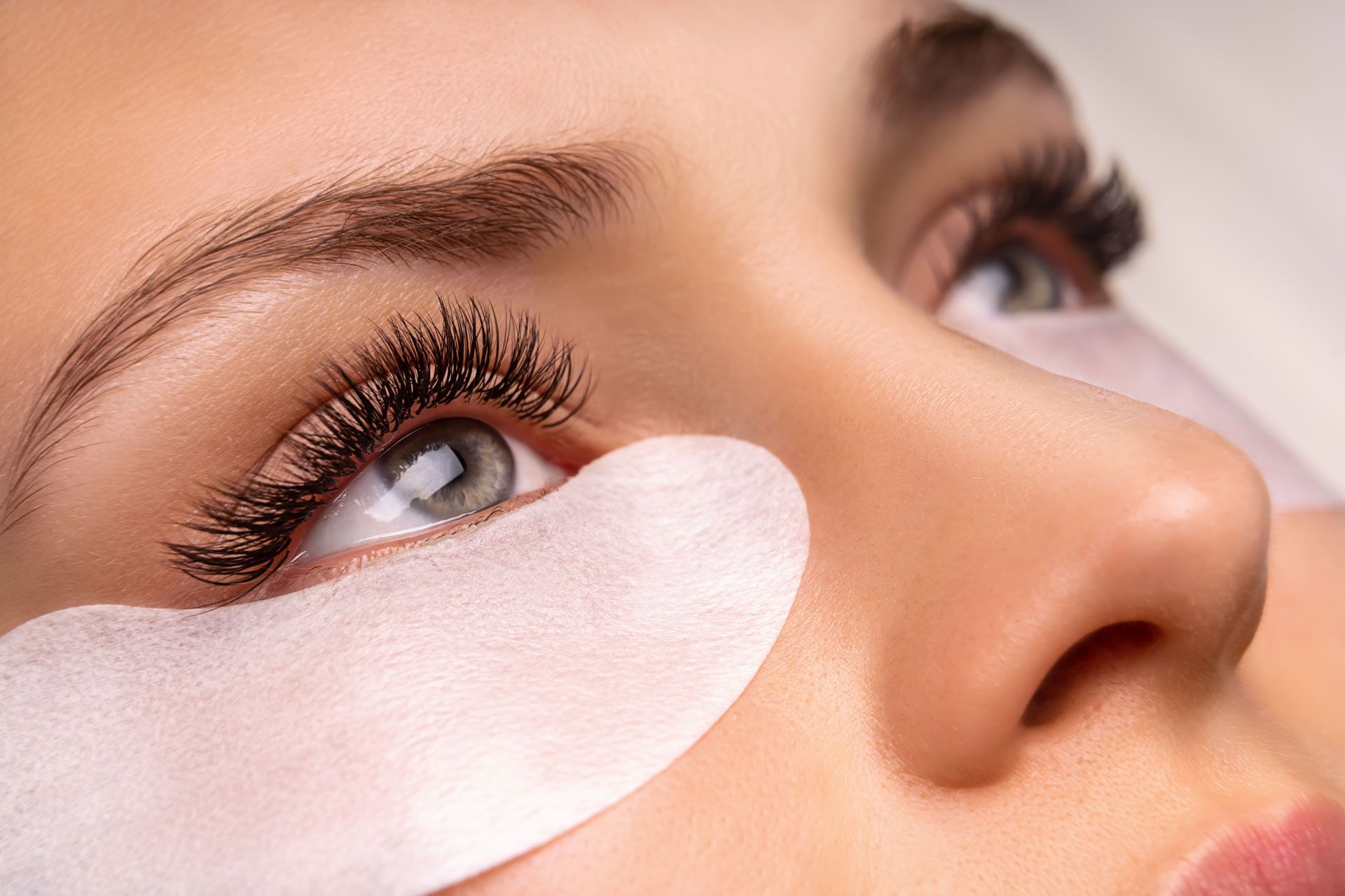 A close up of a woman 's eye with eye patches on it