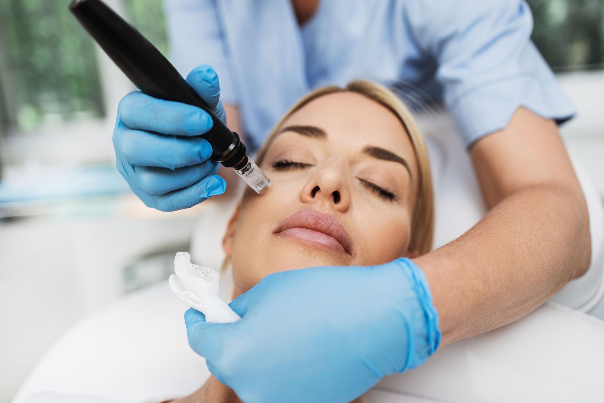 A woman is getting a facial treatment at a spa.