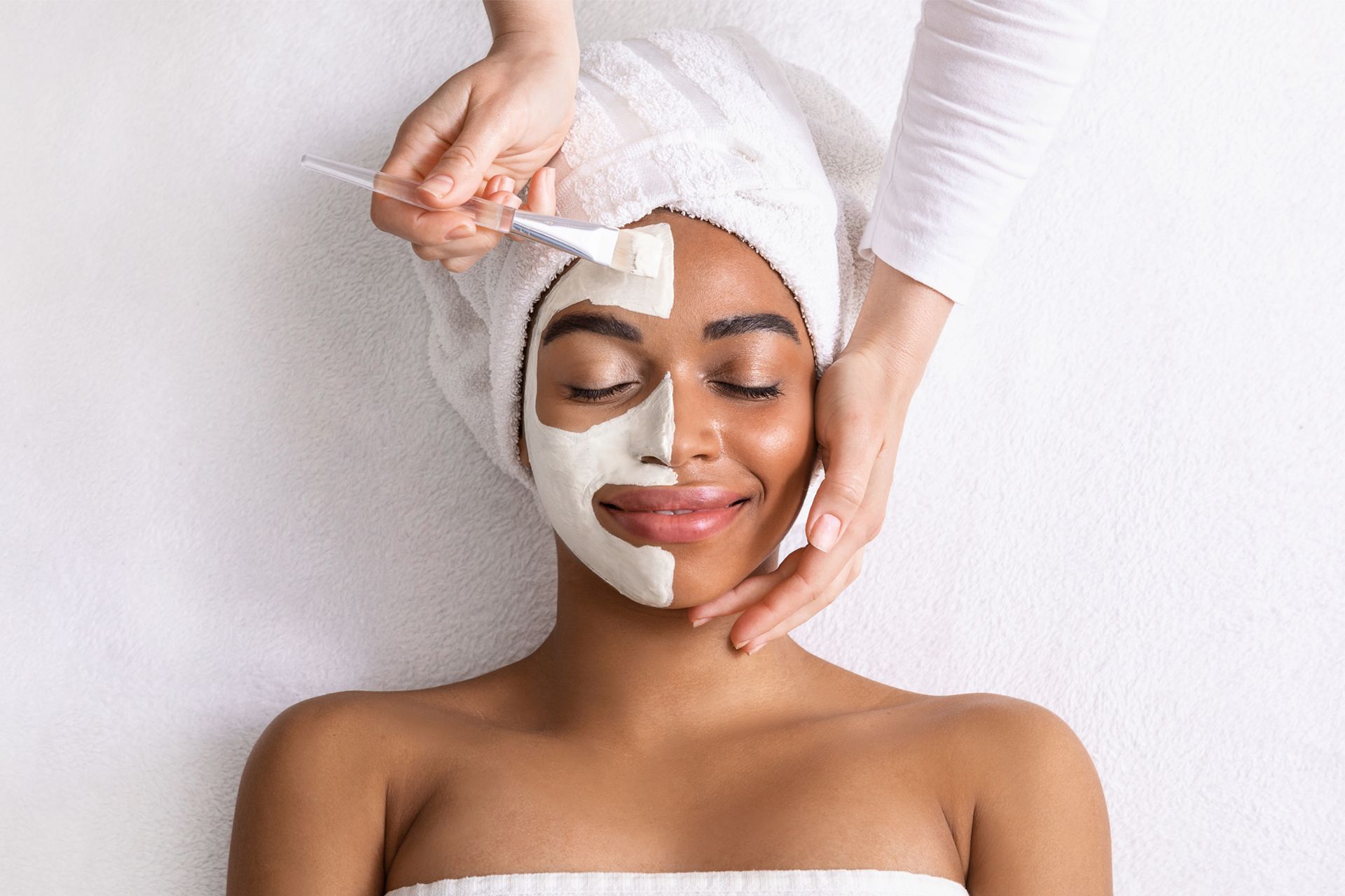 A woman is getting a facial treatment at a spa.