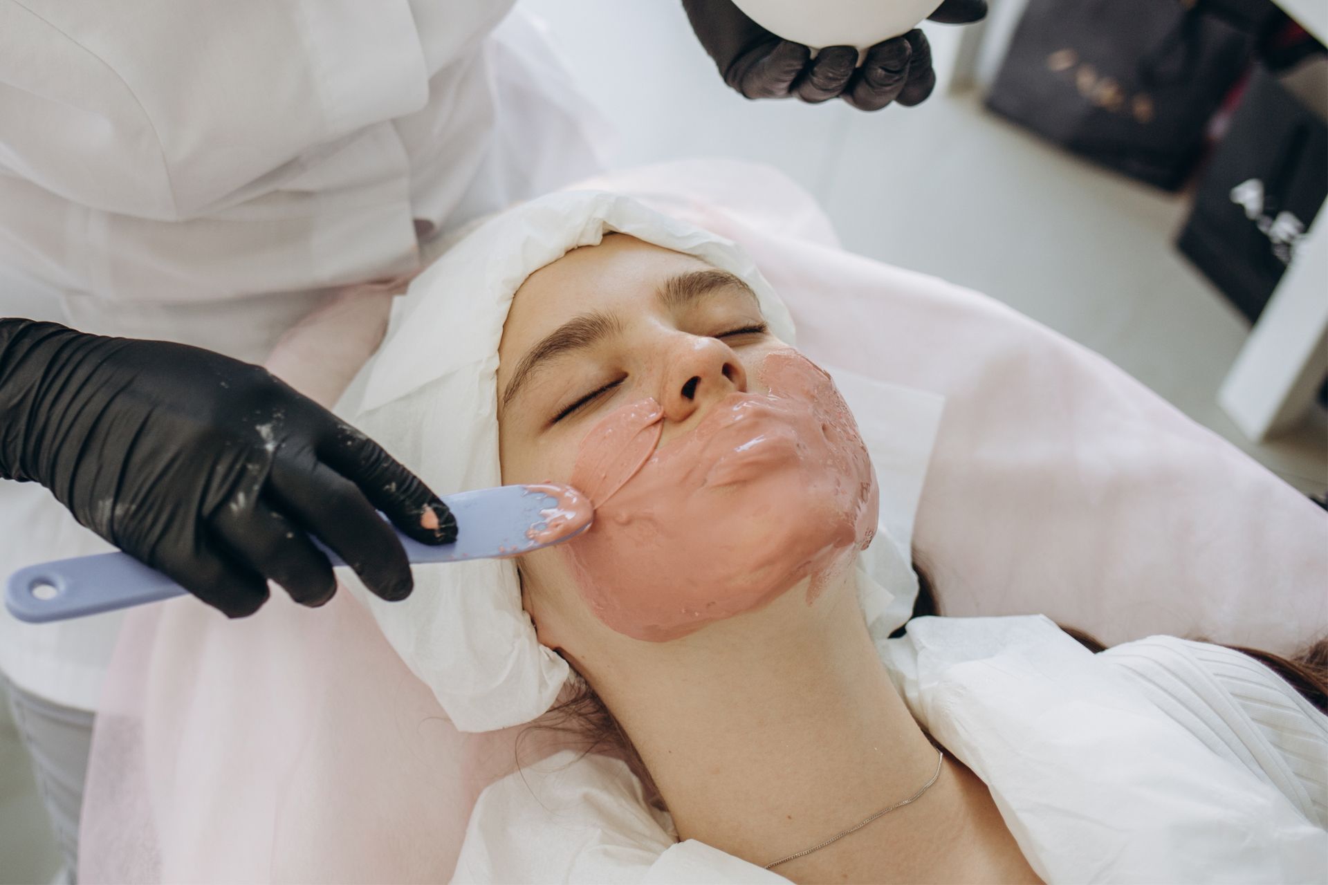 A woman is getting a co₂ carboxy facial treatment at a beauty salon.