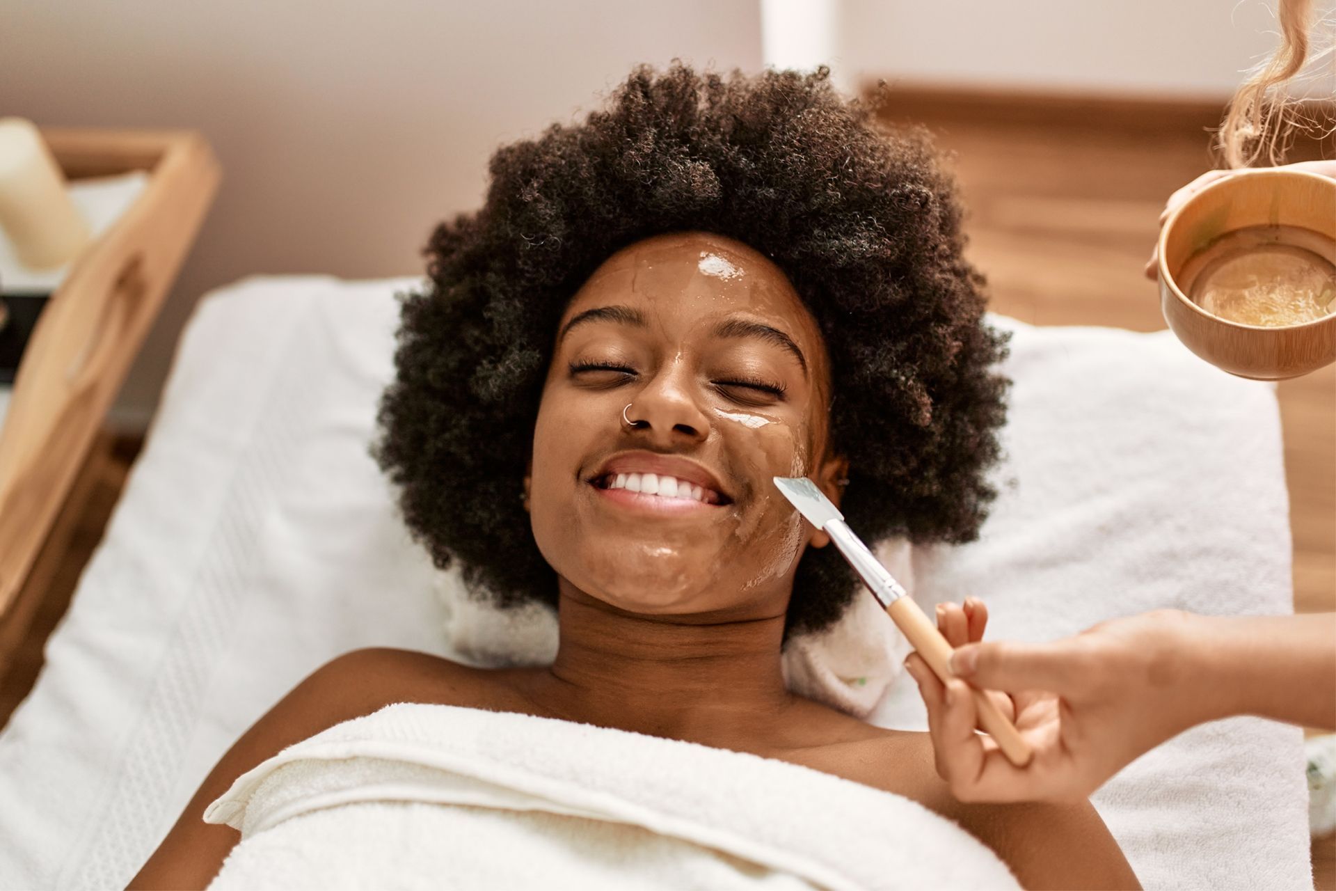 A woman is getting a facial treatment at a spa.