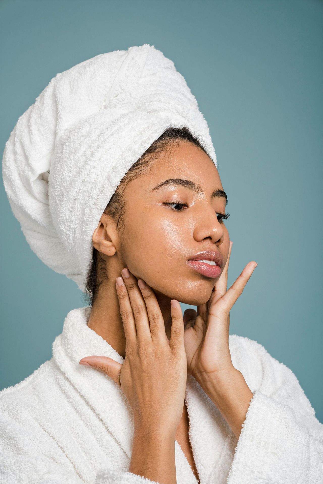 A woman is laying on a bed getting a massage on her stomach.
