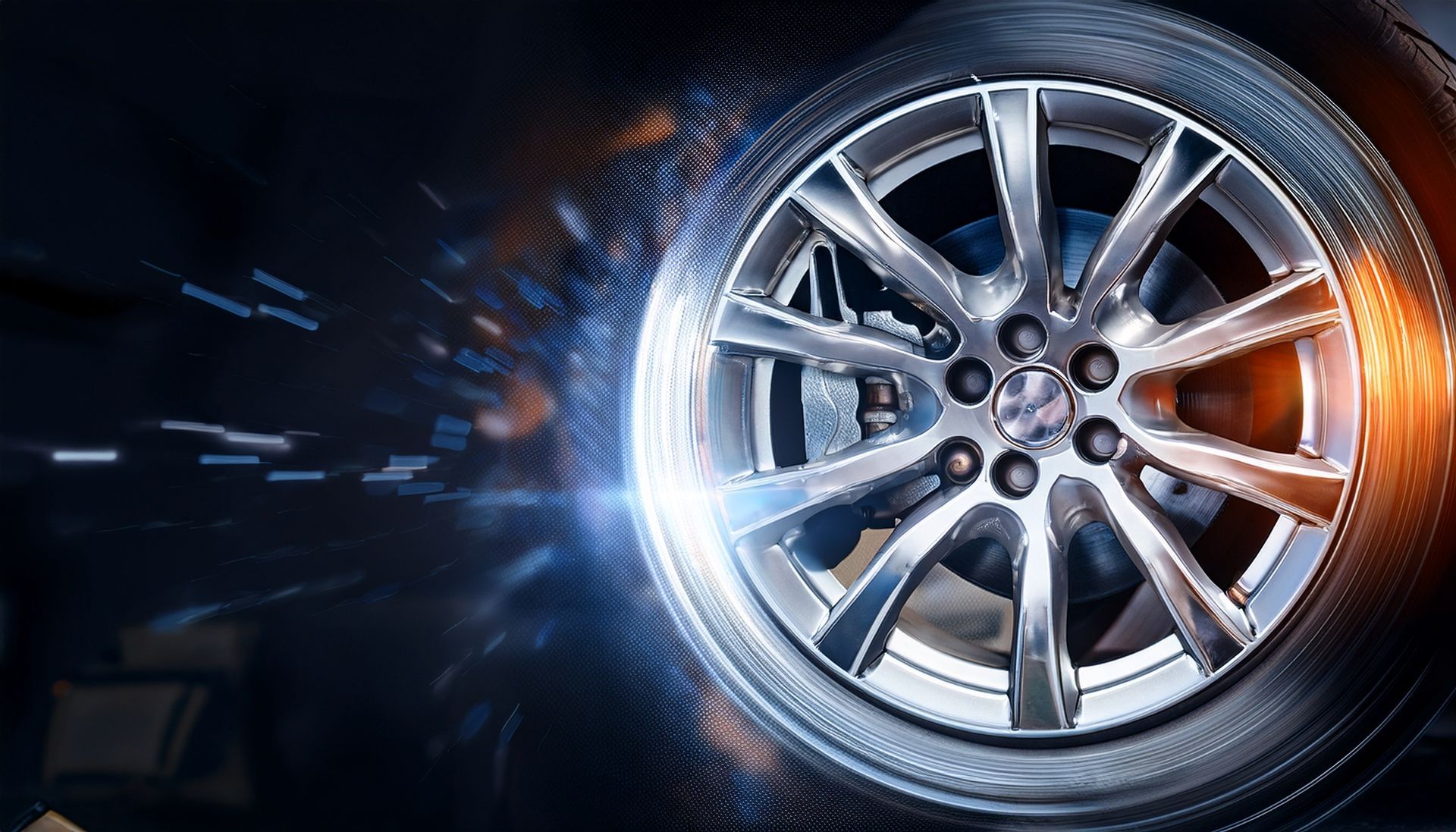 A shiny car wheel against a dark background with blue and orange light effects and motion blur.