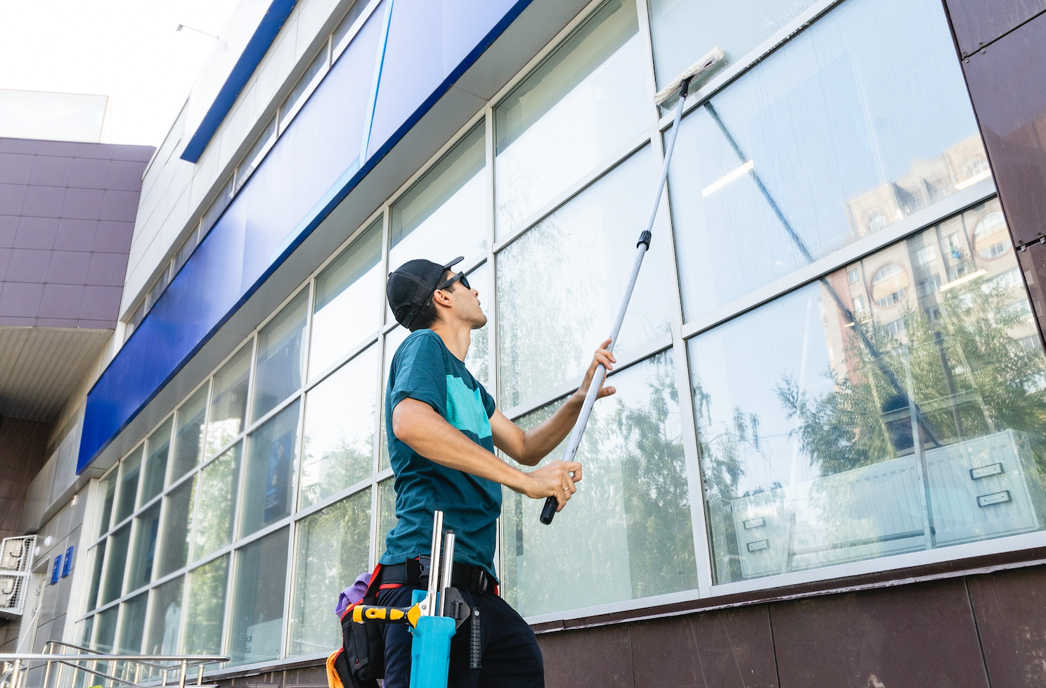 A man is cleaning the windows of a building.