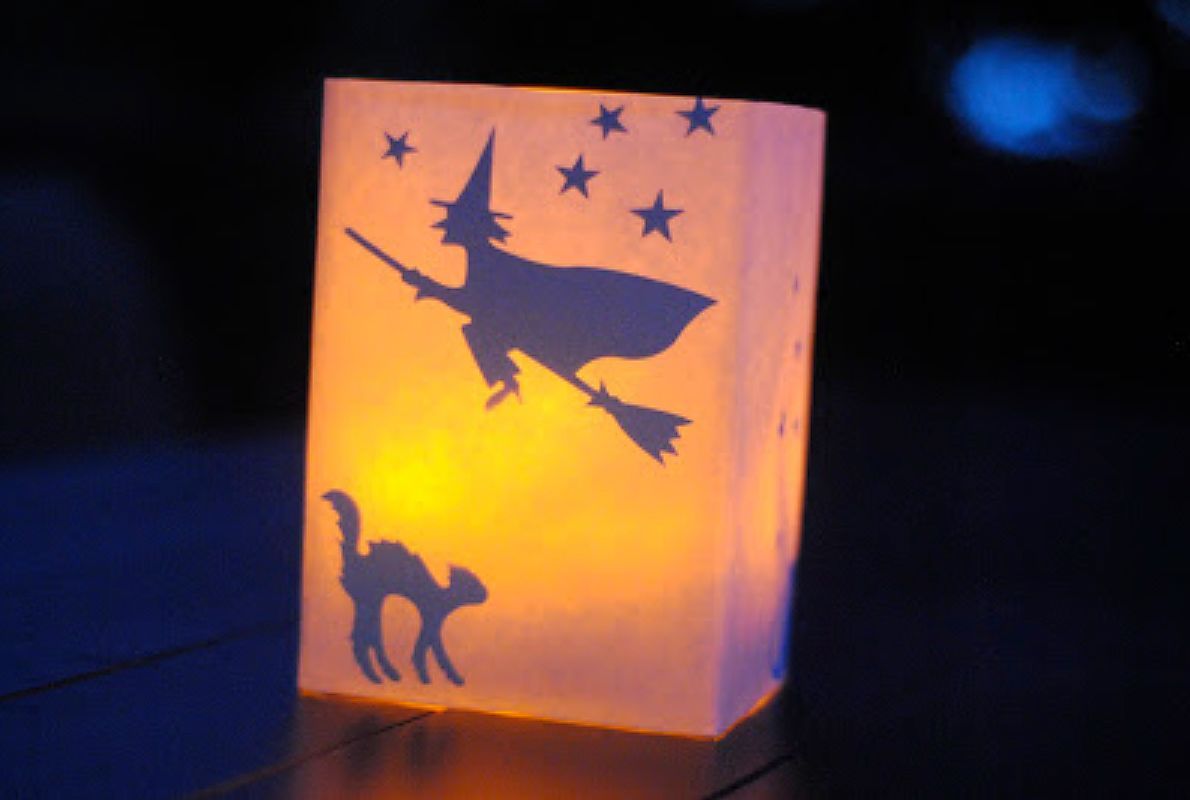 A paper lantern with a witch and a cat on it