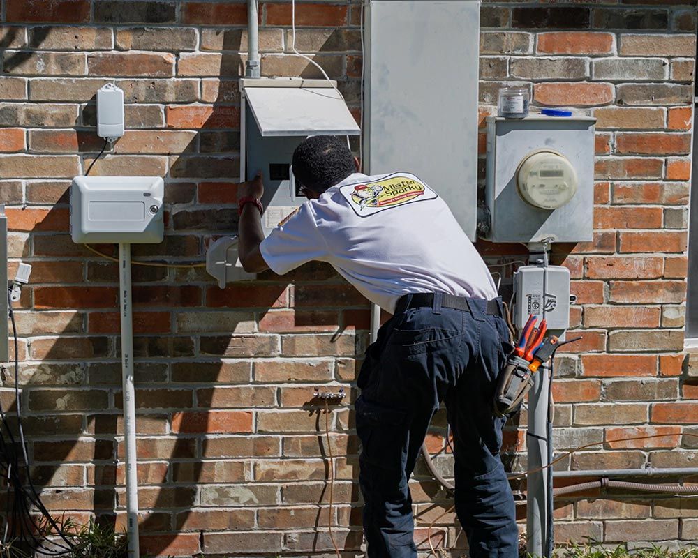 man updating exterior circuit breaker panel