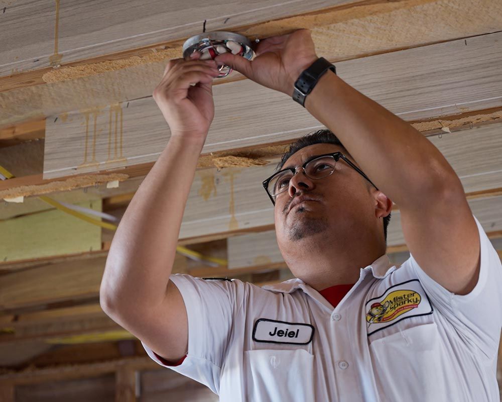 man installing smoke detector