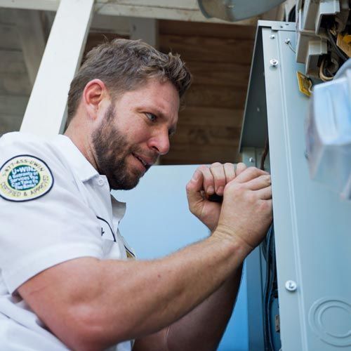 a mister sparky electrician in a white shirt with a patch on his shoulder