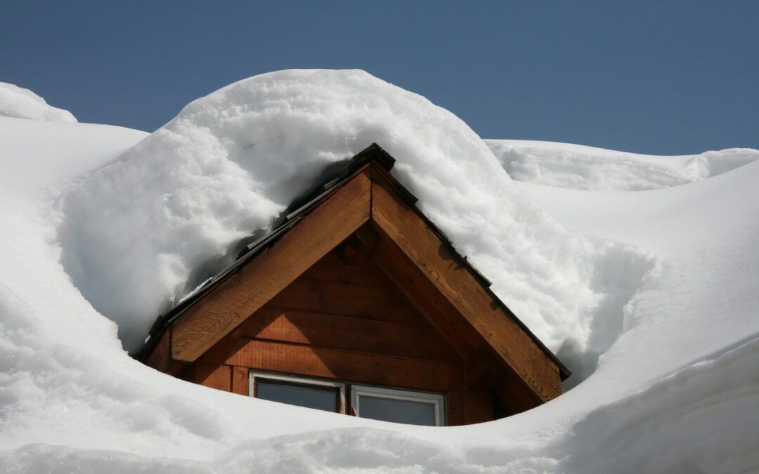 The roof of a house is covered in snow