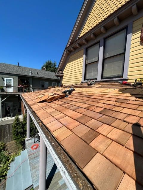 A wooden shingle roof is being installed on a house in Puyallup, WA