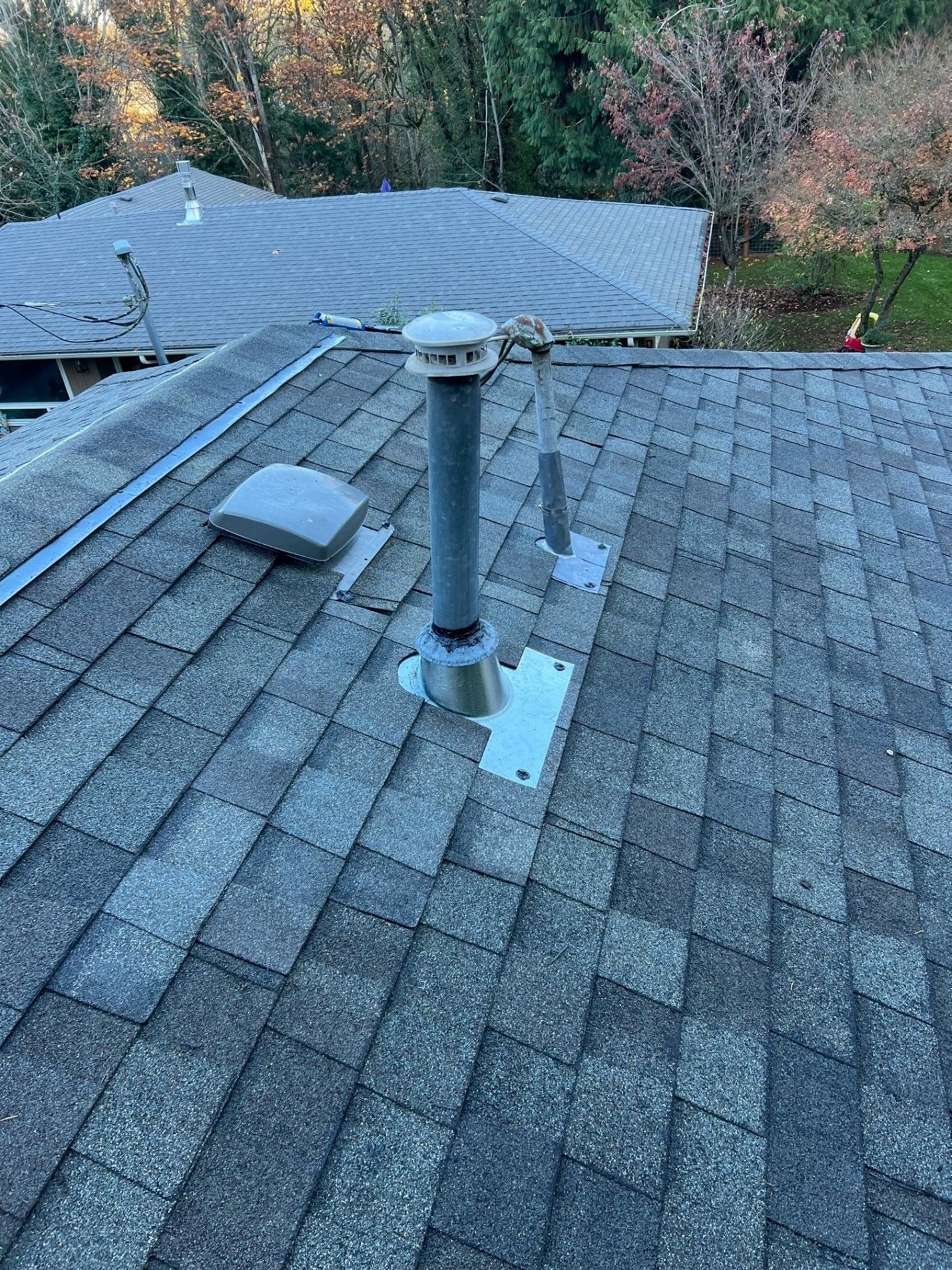 There is a chimney on the roof of a house.