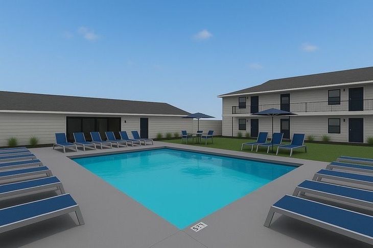 Pool area with turquoise water, lounge chairs, and a two-story apartment building.