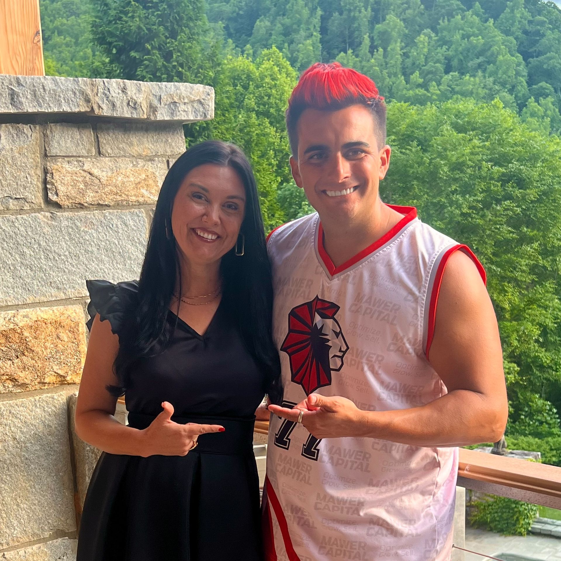 A man and a woman are posing for a picture and the man has red hair