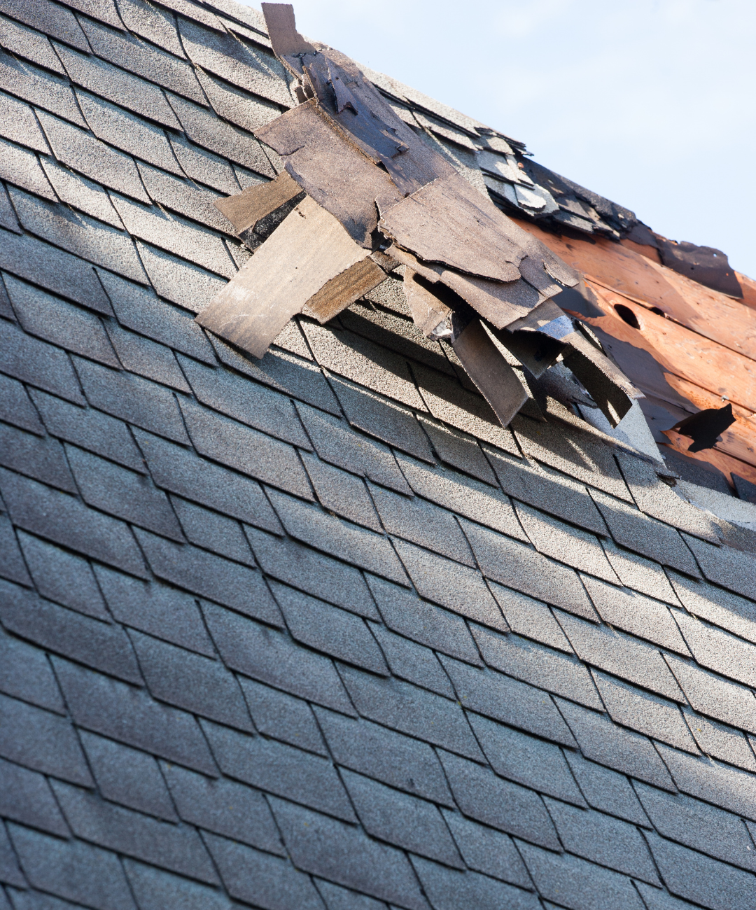 A close up of a roof with a lot of shingles missing