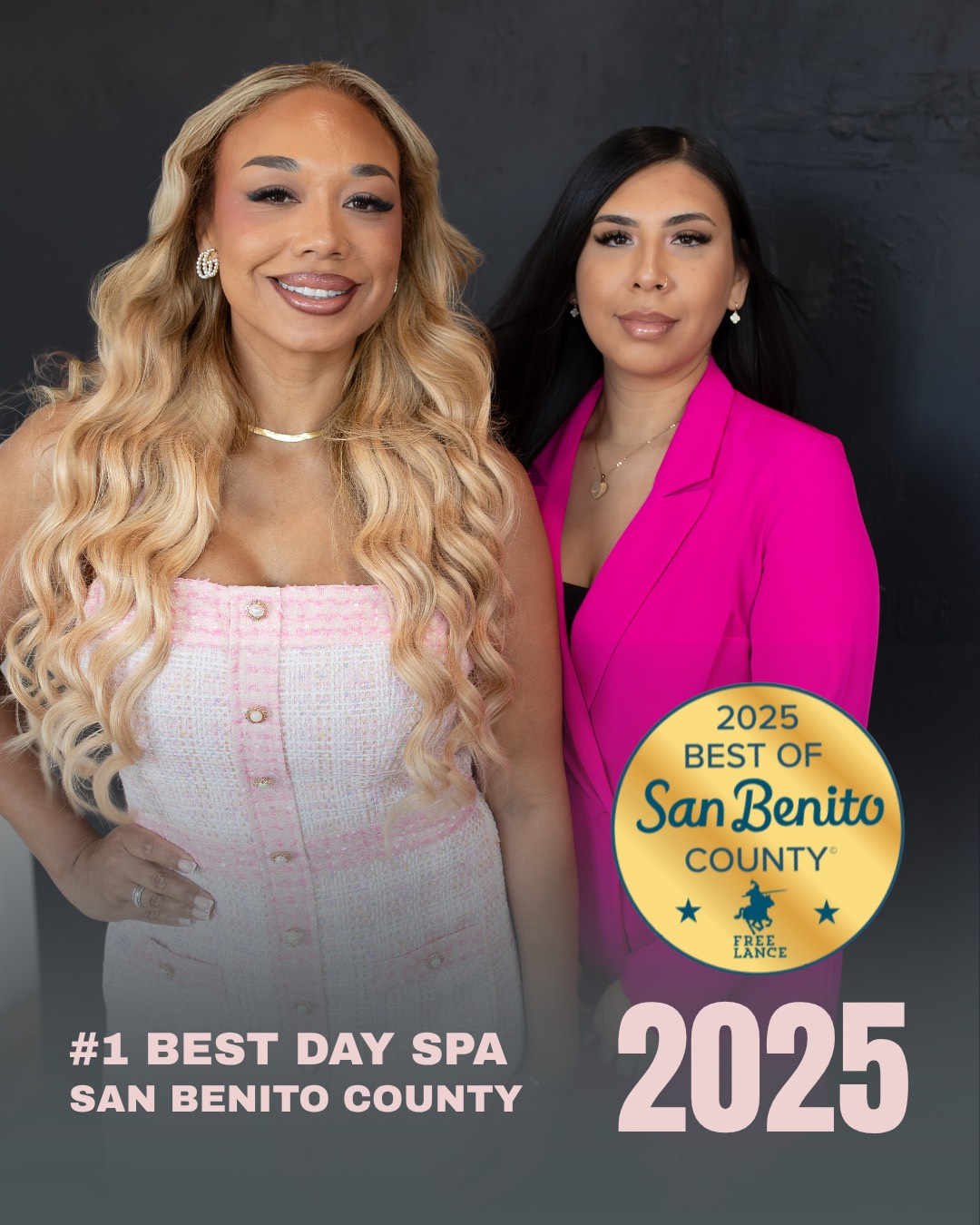 Two women in front of a backdrop, with a 