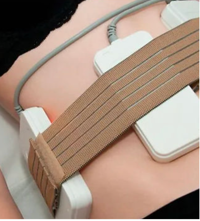 A close up of a person 's stomach with a belt around it.