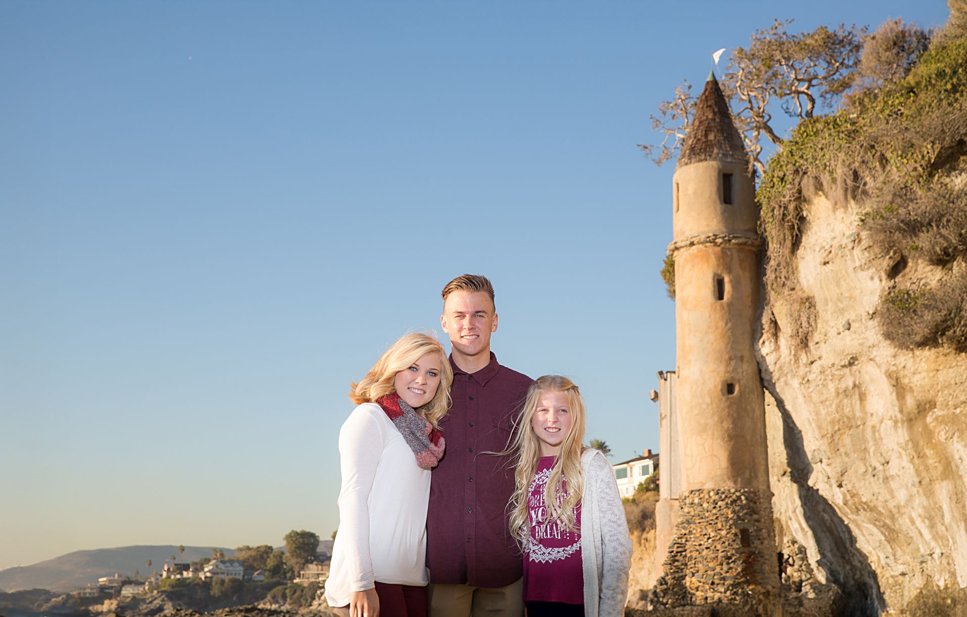 Siblings at Victoria Beach posing in front of the Pirate Tower.