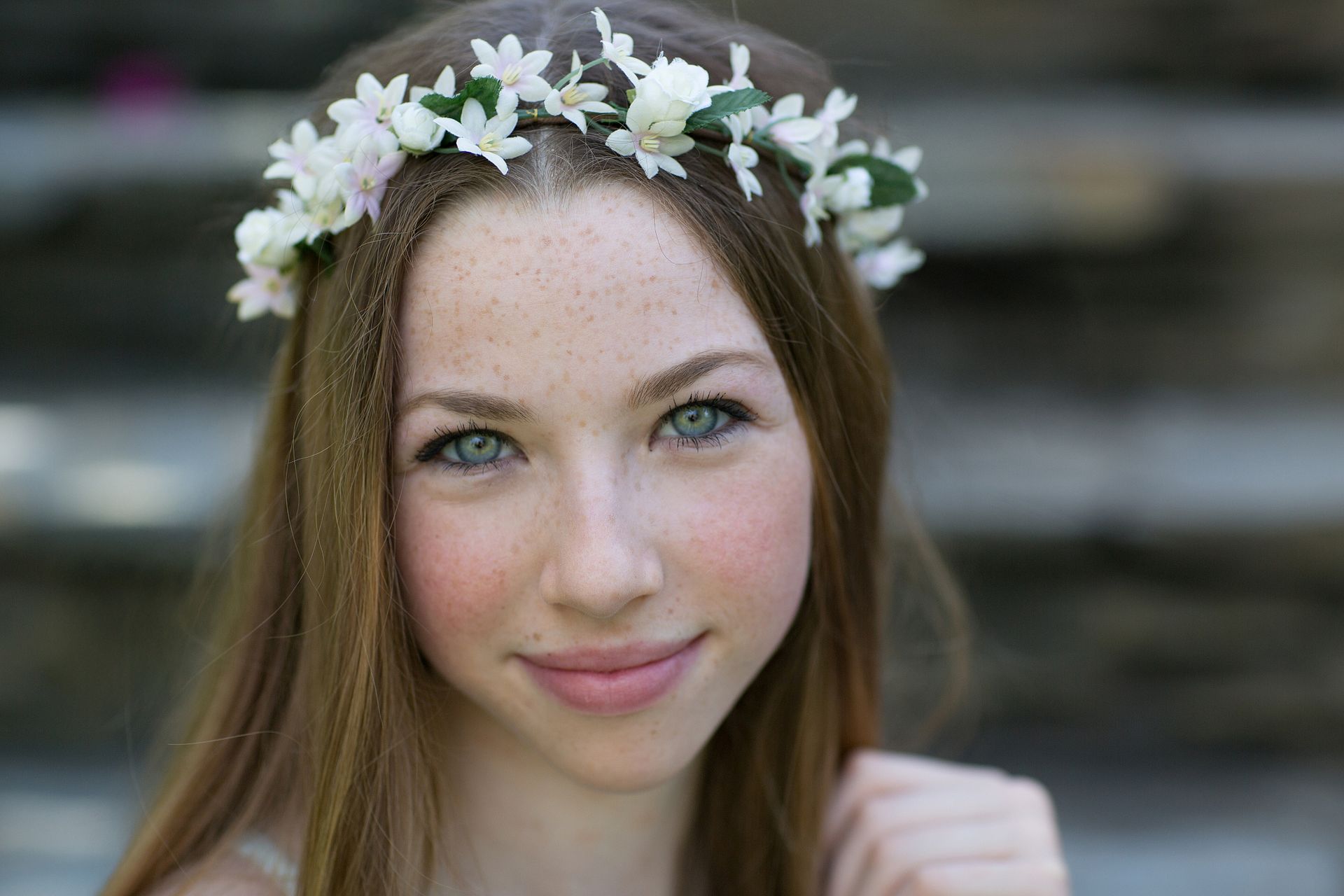 close up portrait of daughter with green eyes in front the her outdoor steps at home