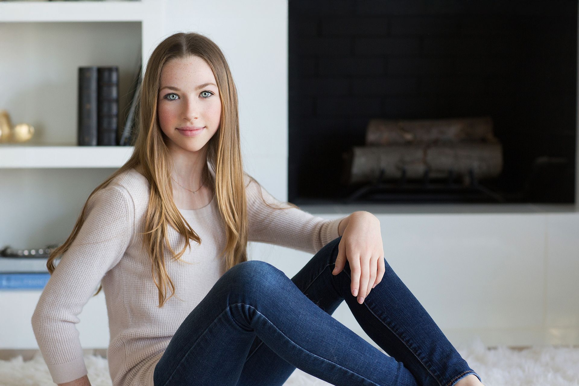 Portrait of oldest daughter in home in front of the fire place in San Juan Capistrano