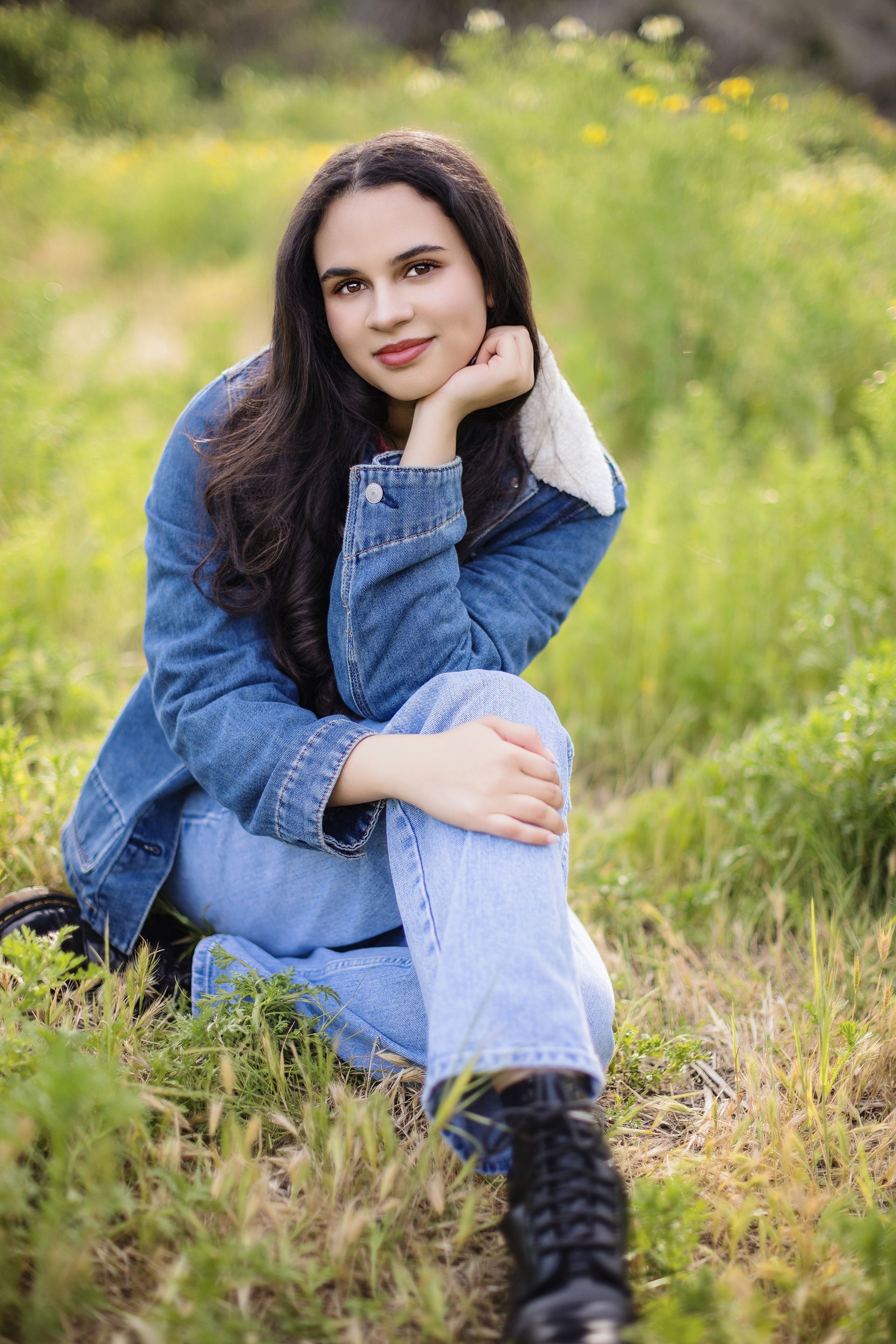 High school senior enjoying a sunny day in an Orange County field, part of a premium senior portrait session