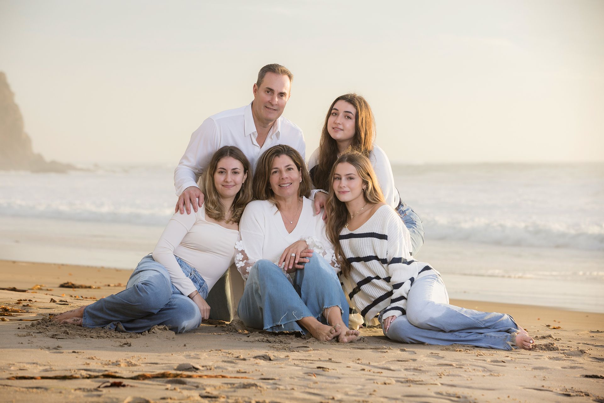 Family of five posing for a professional family portrait at Strands Beach at sunset in Dana Point.