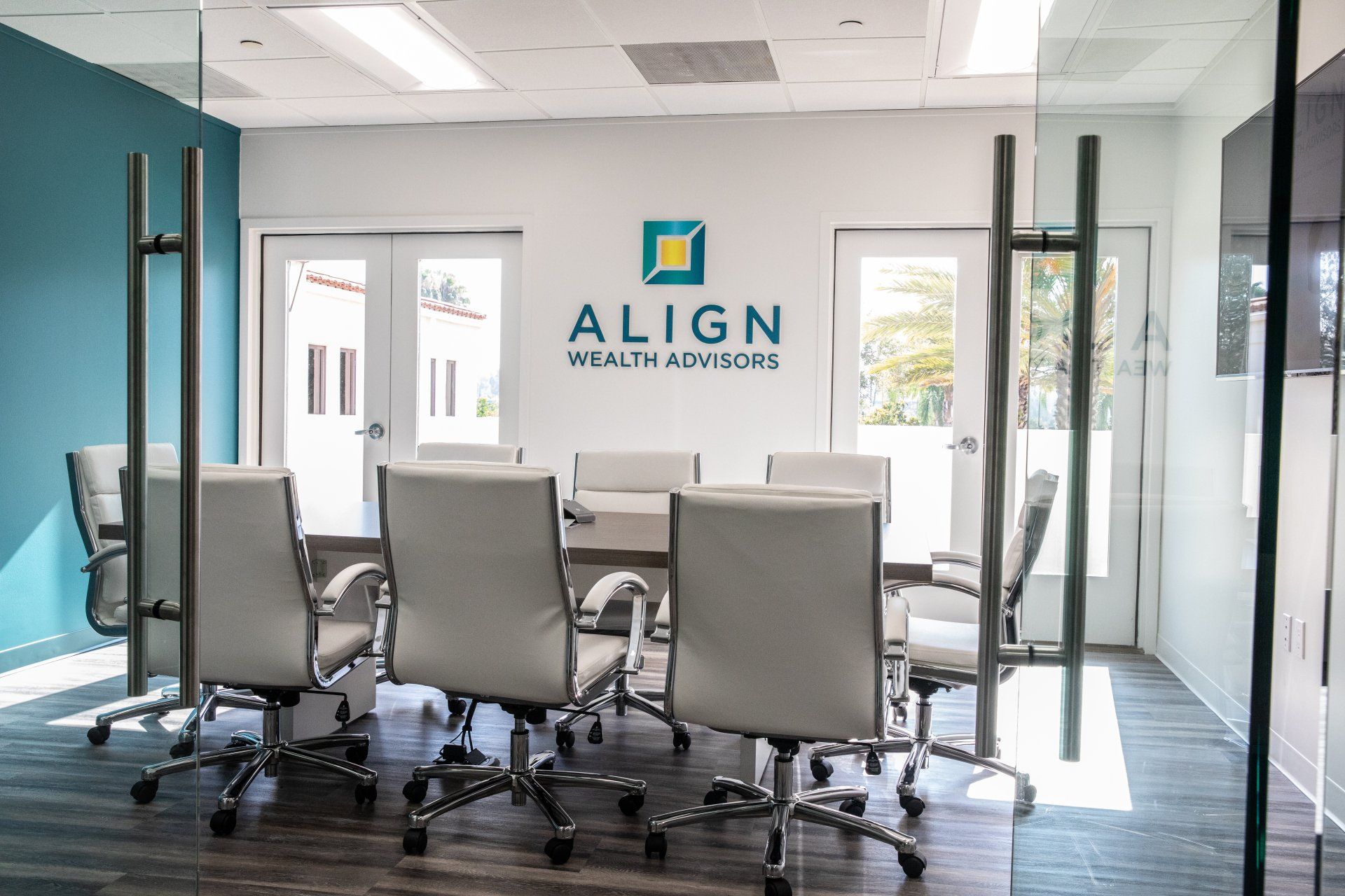 A conference room with a table and chairs and a sign that says align wealth advisors.