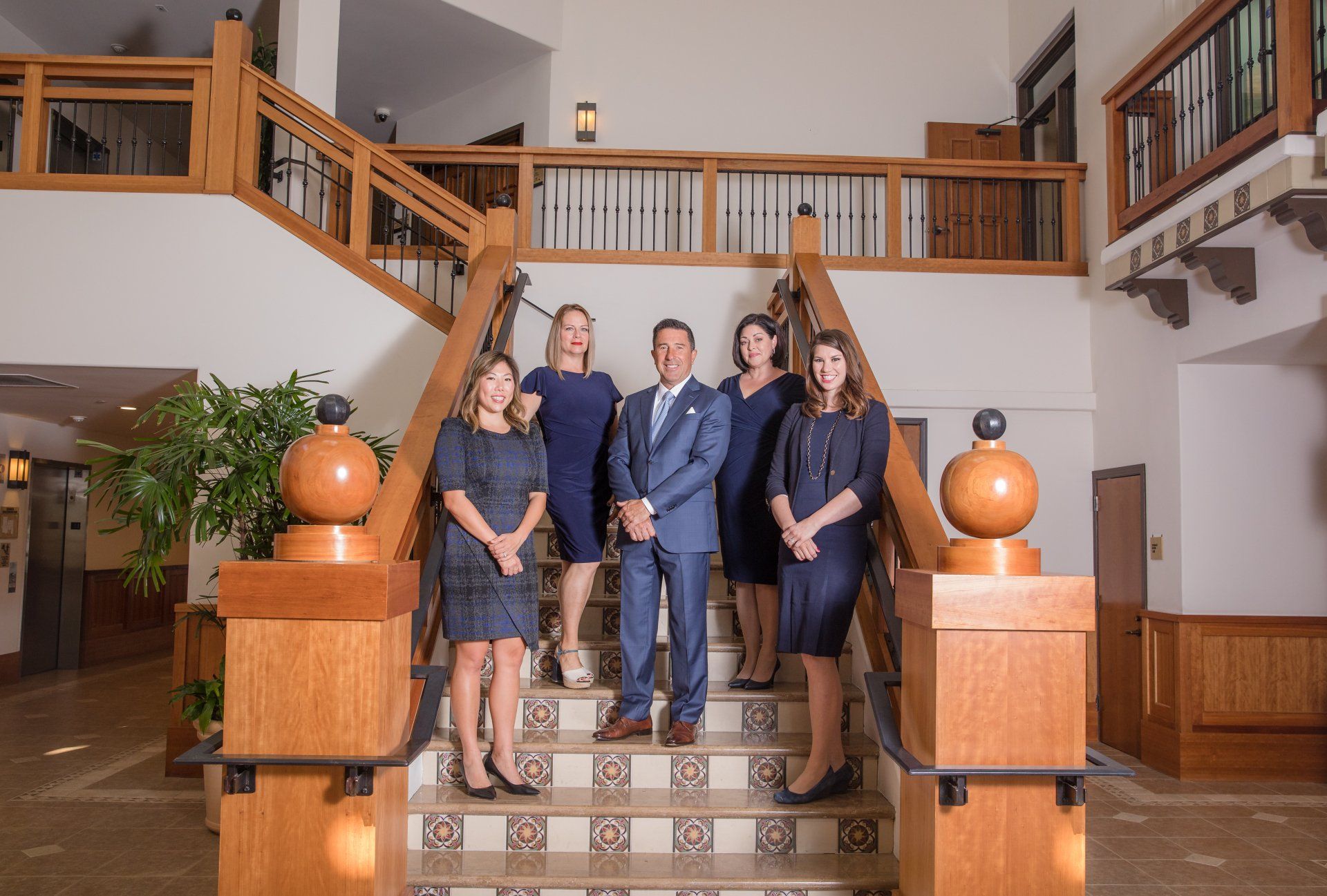 A group of people are standing on a set of stairs.