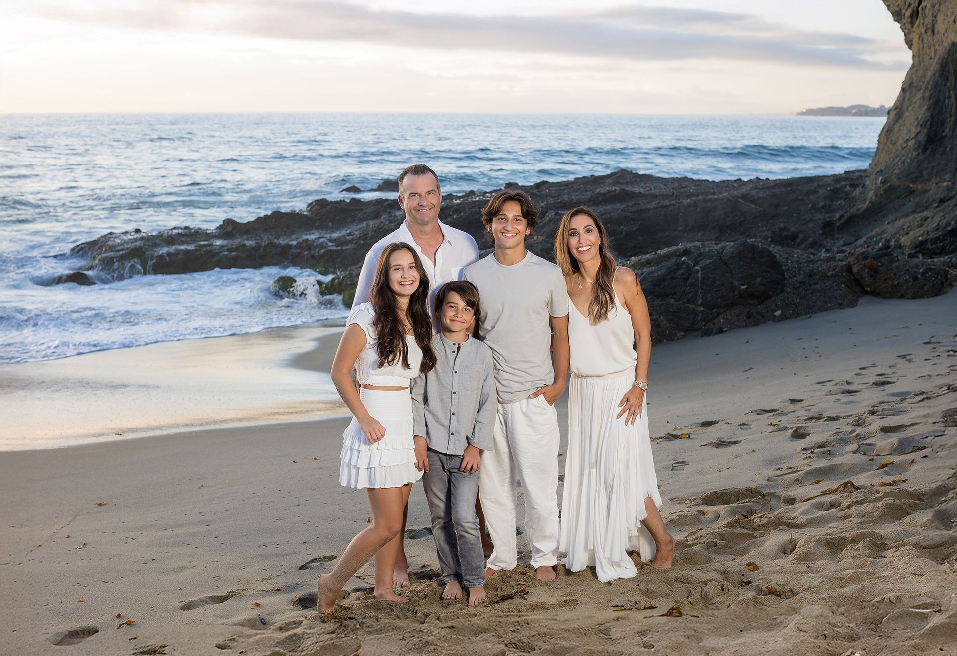 Family portrait of five at Goff Point at the Montage Resort in Laguna Beach.  Entire family dressed in whites and shades of grey.